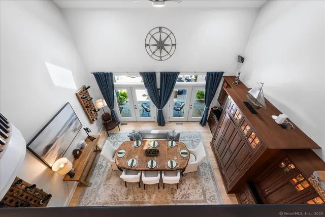 a view of a dining room with furniture wooden floor and a chandelier
