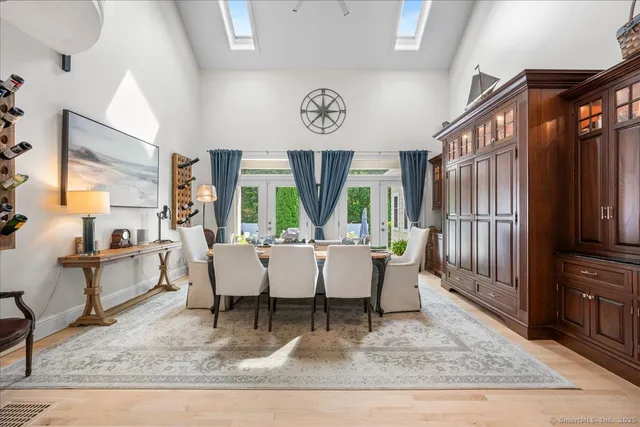 a living room with couches coffee table and kitchen view with wooden floor