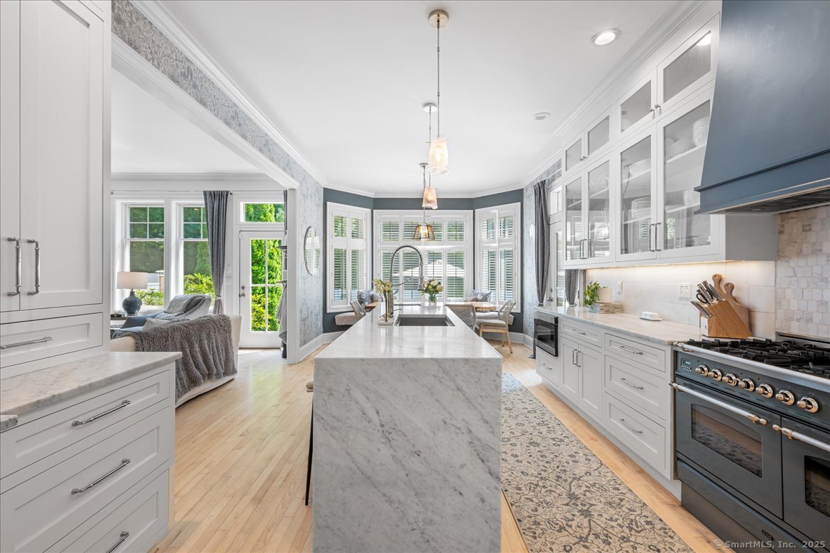 4 Laconia Drive Clinton, CT 06413 - Photo 19 of 40 a large white kitchen with sink and wooden floors