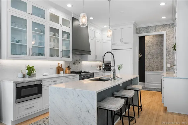 a kitchen with granite countertop a sink stove and cabinets