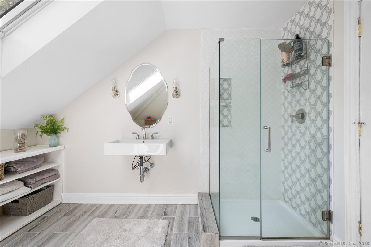 4 Laconia Drive Clinton, CT 06413 - Photo 26 of 40 a bathroom with a sink a mirror a glass door a shower and vanity