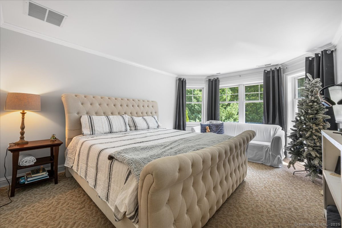 4 Laconia Drive Clinton, CT 06413 - Photo 27 of 40 a bed sitting in a bedroom next to a window