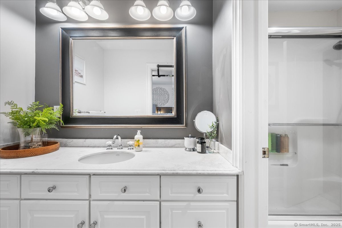 4 Laconia Drive Clinton, CT 06413 - Photo 30 of 40 a bathroom with a sink and a mirror