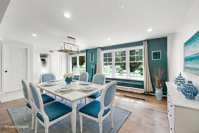 a dining room with furniture window and wooden floor