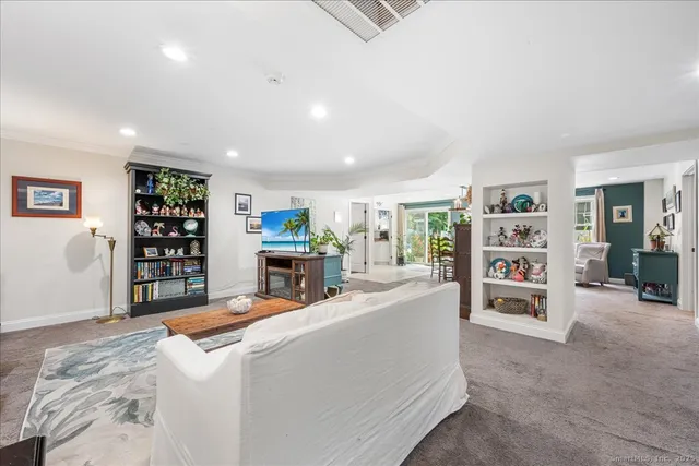 a living room with furniture and a book shelf
