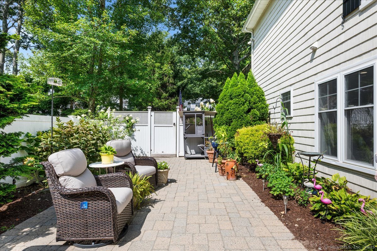 4 Laconia Drive Clinton, CT 06413 - Photo 37 of 40 a view of a patio with table and chairs and potted plants