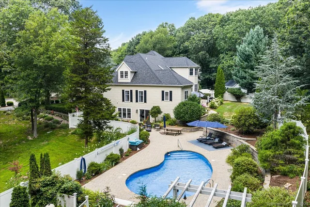 an aerial view of a house with swimming pool garden and patio