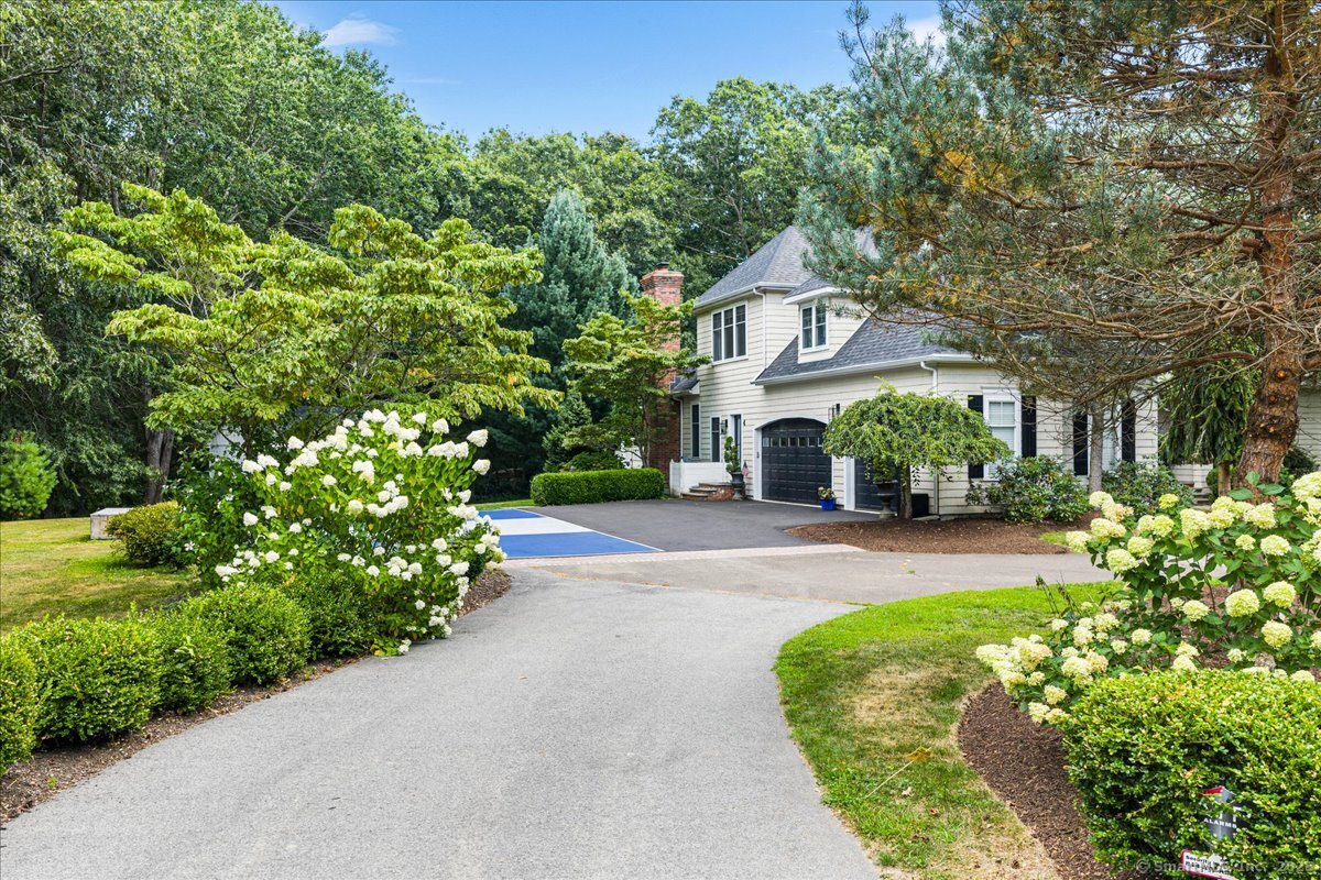 4 Laconia Drive Clinton, CT 06413 - Photo 40 of 40 a front view of a house with a yard and fountain in middle