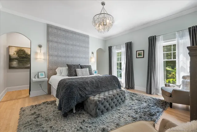 a living room with a bed furniture and a window