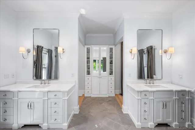 a bathroom with double vanity sink and a mirror