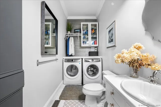 a bathroom with a toilet sink and mirror