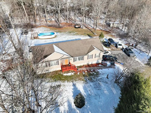 a view of a house with a yard and sitting area
