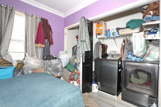 a bedroom with pink walls and pink bed