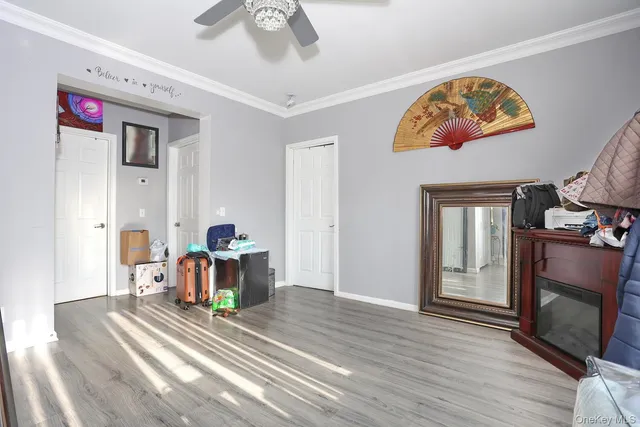 a view of a livingroom with wooden floor and a fireplace