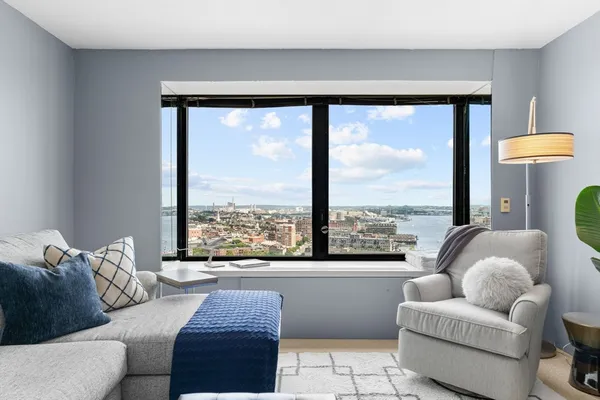 a living room with furniture and a large window