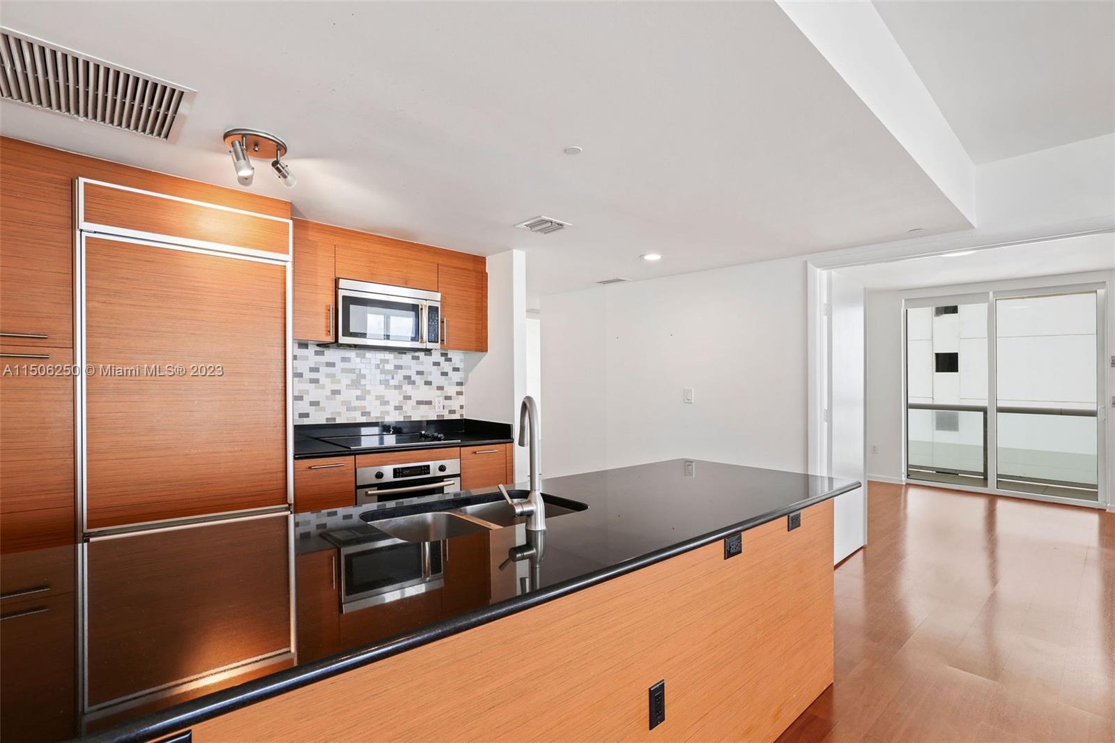 50 Biscayne Boulevard, Unit 3102 Miami, FL 33132 - Photo 11 of 43 a kitchen with stainless steel appliances a refrigerator and a stove top oven