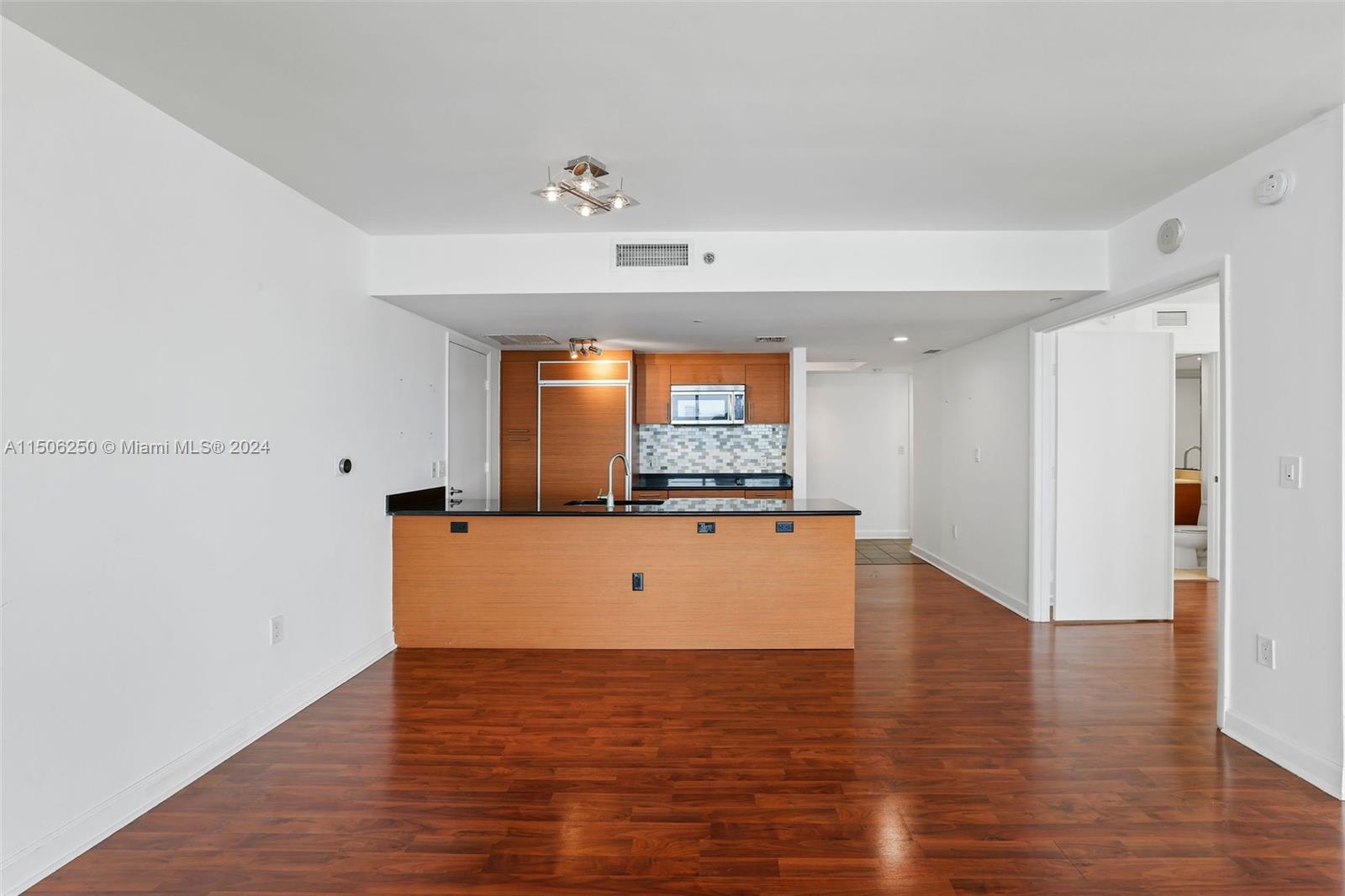 50 Biscayne Boulevard, Unit 3102 Miami, FL 33132 - Photo 13 of 43 a room with wooden floor and window