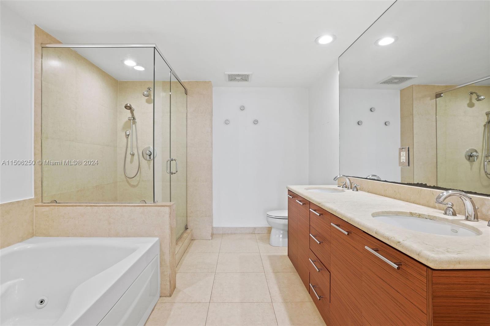 50 Biscayne Boulevard, Unit 3102 Miami, FL 33132 - Photo 17 of 43 a bathroom with a tub sink shower and mirror