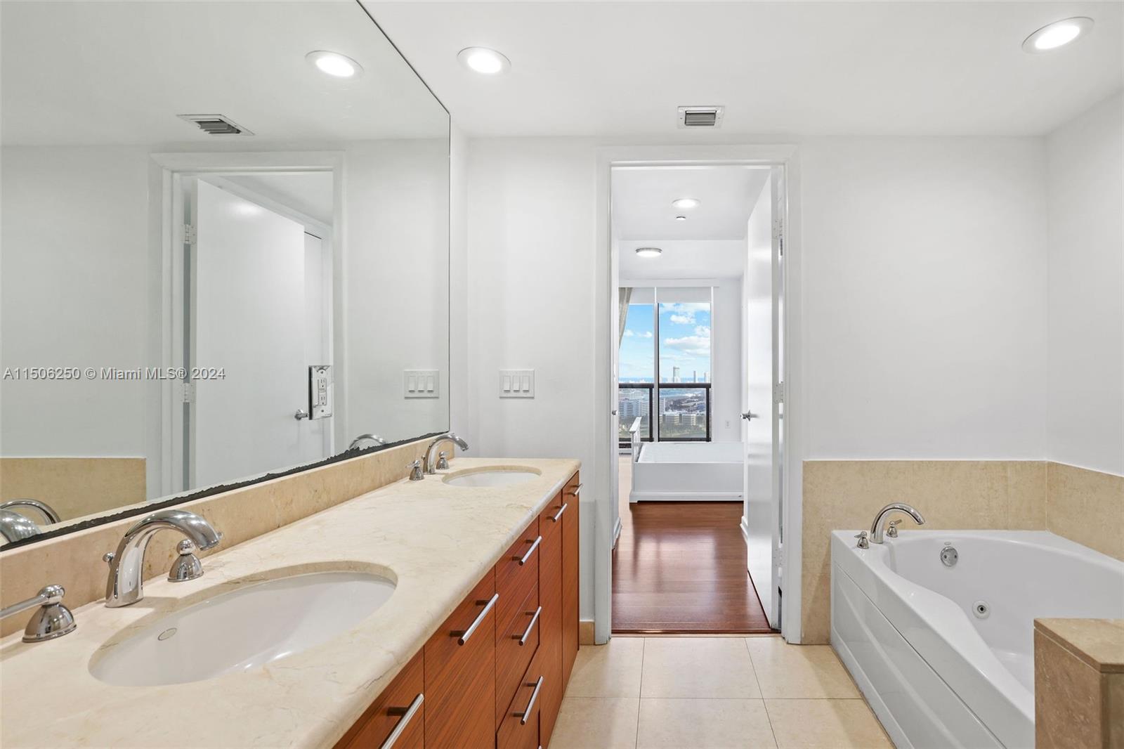 50 Biscayne Boulevard, Unit 3102 Miami, FL 33132 - Photo 18 of 43 a bathroom with a tub double sink and mirror