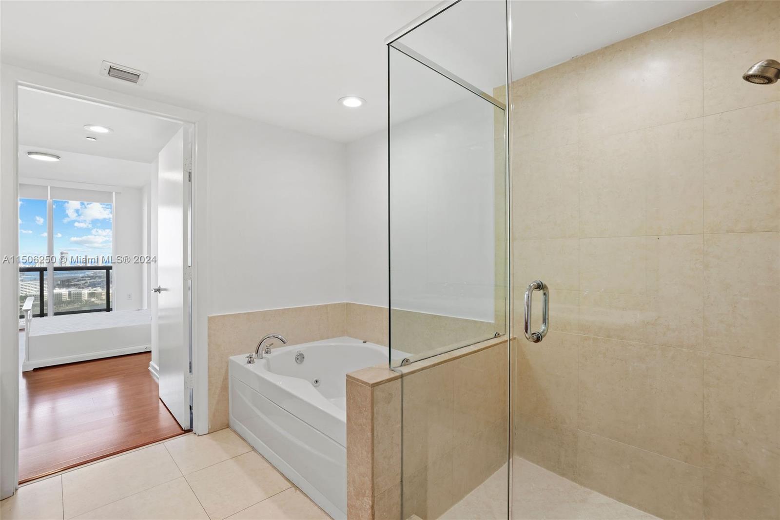 50 Biscayne Boulevard, Unit 3102 Miami, FL 33132 - Photo 20 of 43 a bathroom with a tub and shower
