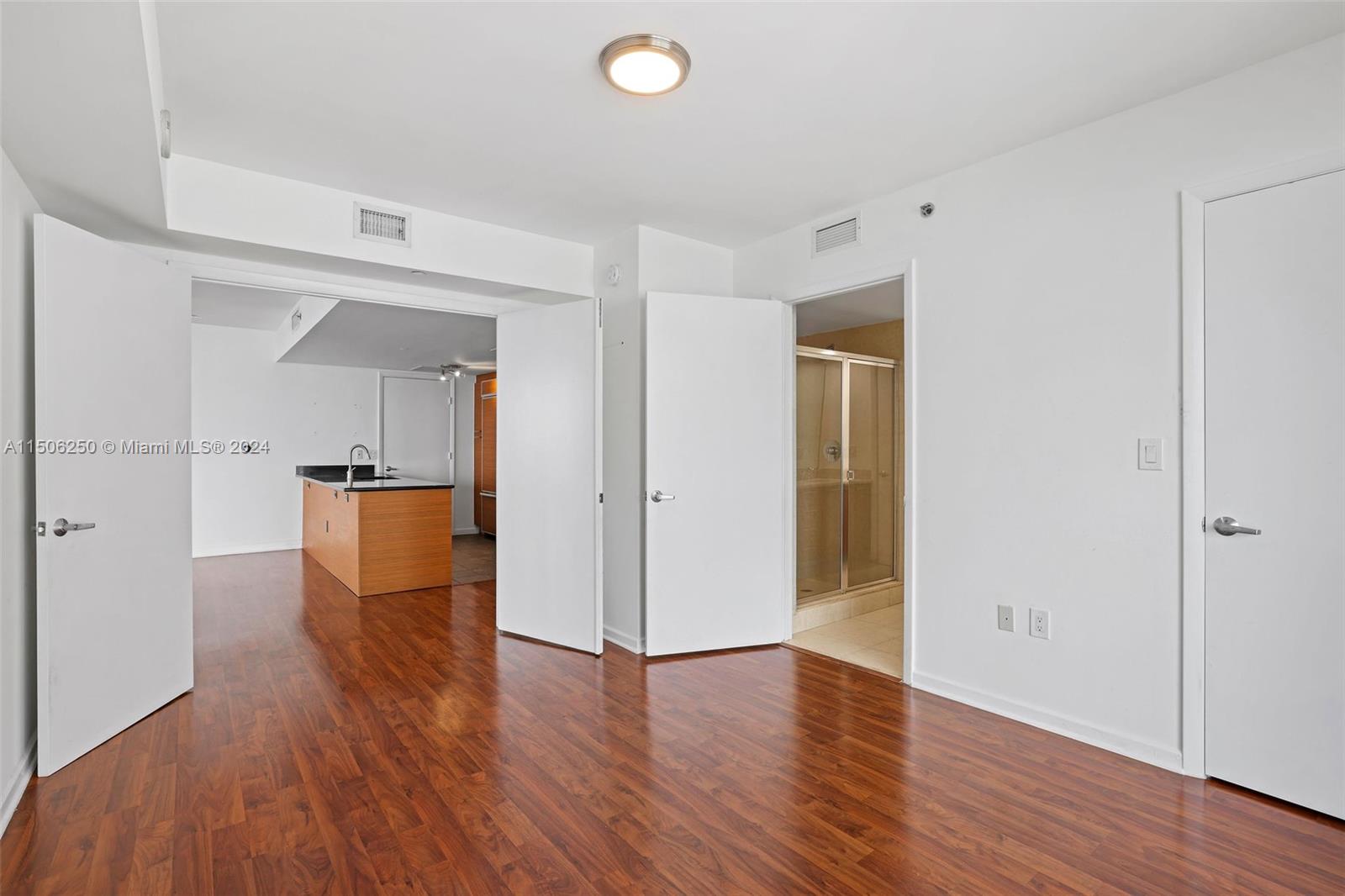 50 Biscayne Boulevard, Unit 3102 Miami, FL 33132 - Photo 22 of 43 a view of empty room with wooden floor