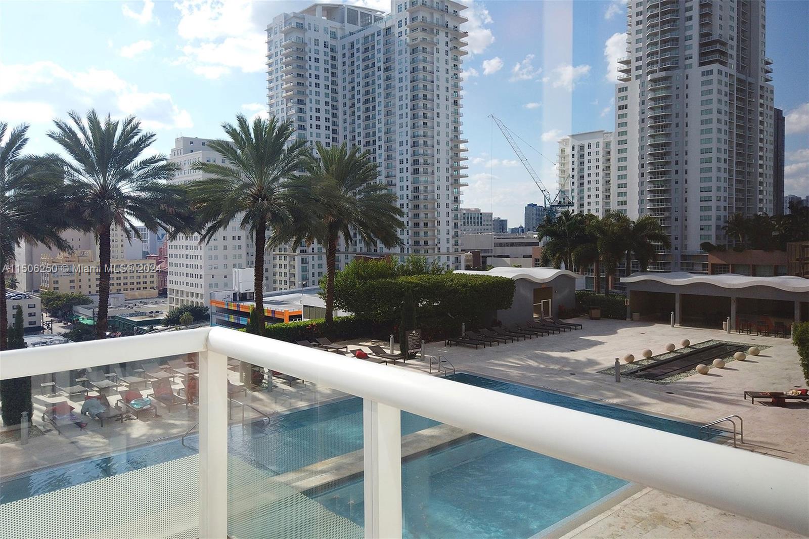50 Biscayne Boulevard, Unit 3102 Miami, FL 33132 - Photo 41 of 43 a view of a swimming pool with a lounge chairs
