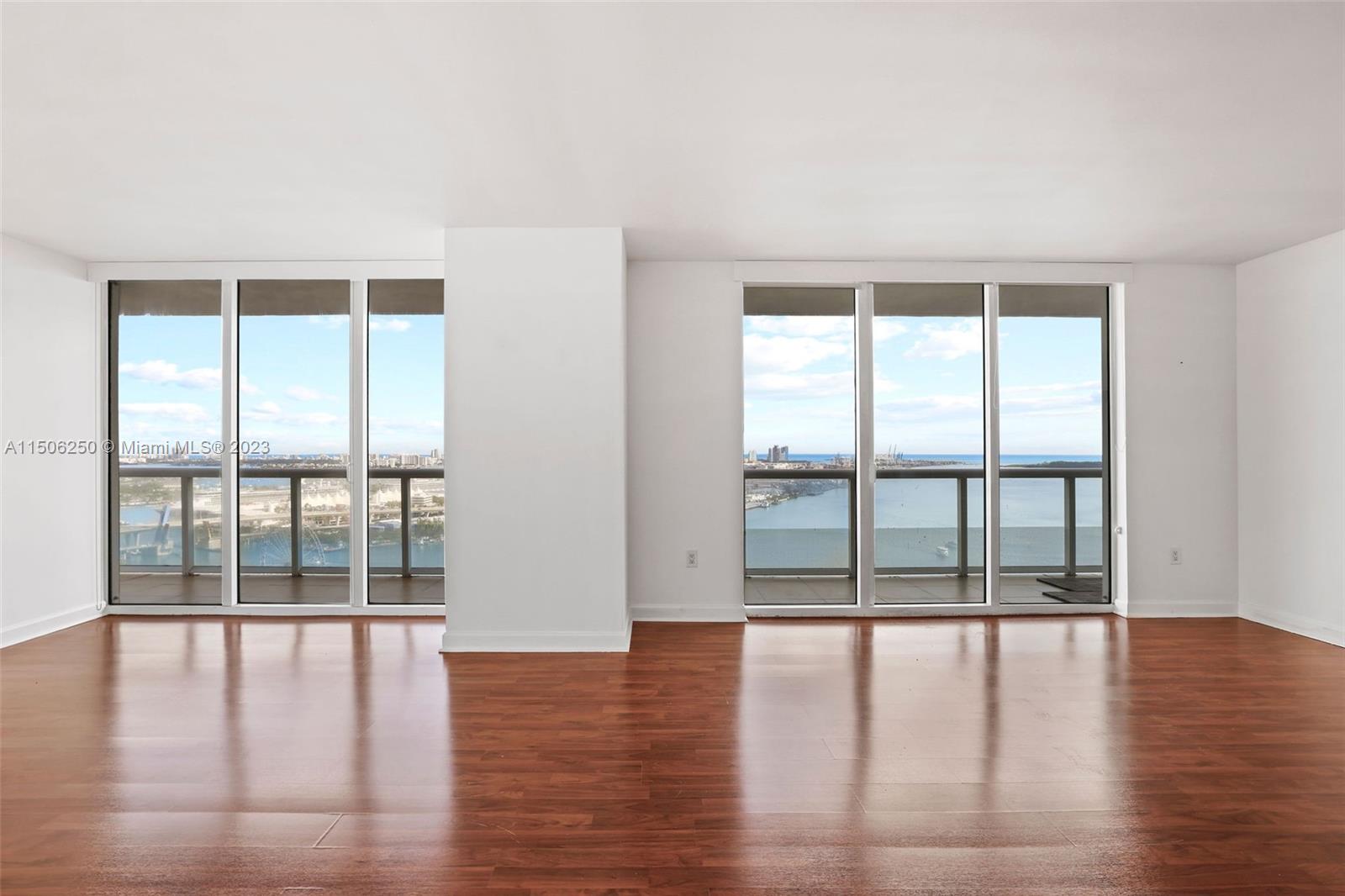 50 Biscayne Boulevard, Unit 3102 Miami, FL 33132 - Photo 6 of 43 wooden floor in an empty room with a window