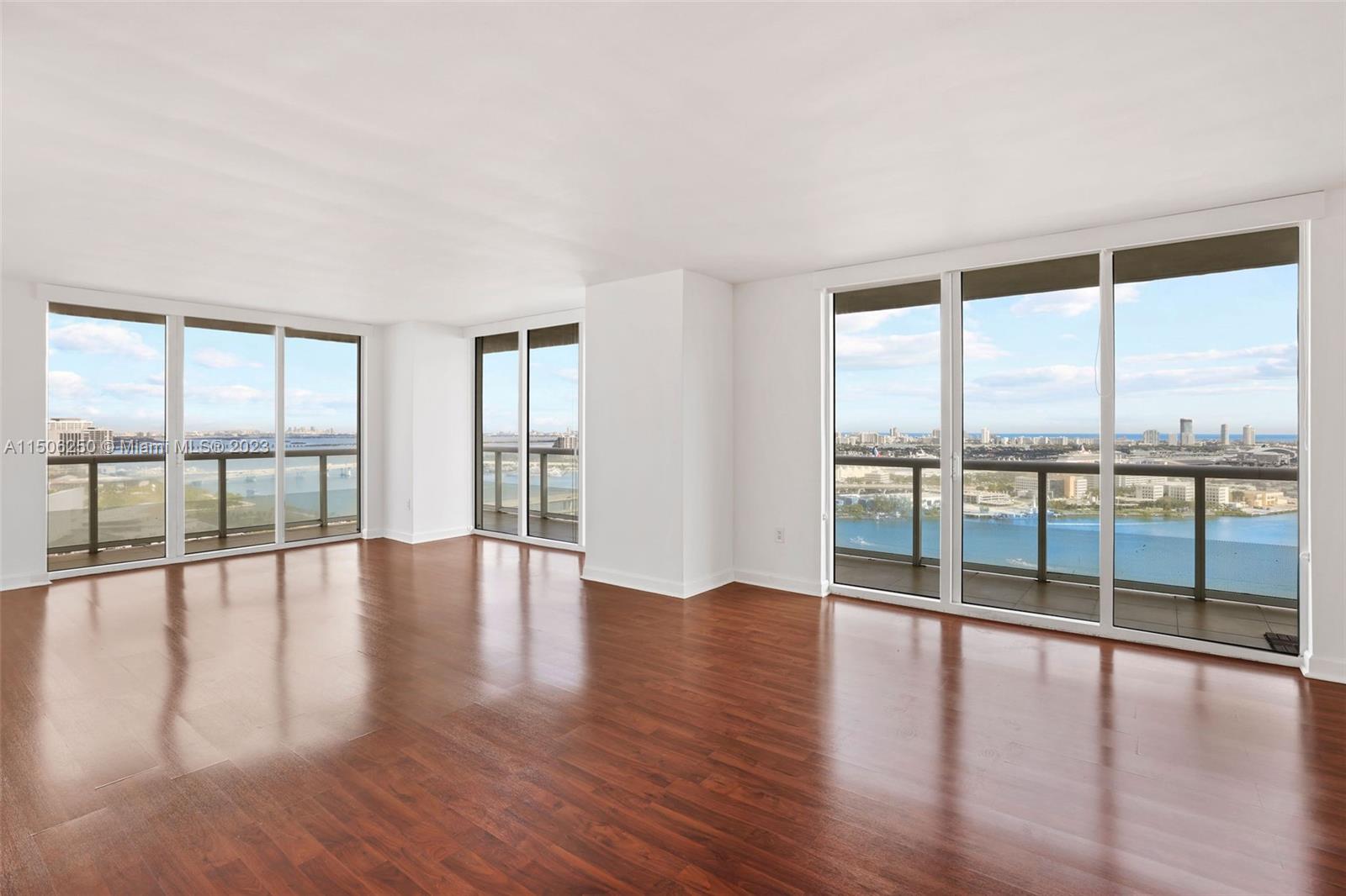 50 Biscayne Boulevard, Unit 3102 Miami, FL 33132 - Photo 8 of 43 a view of an empty room with wooden floor and a floor to ceiling window
