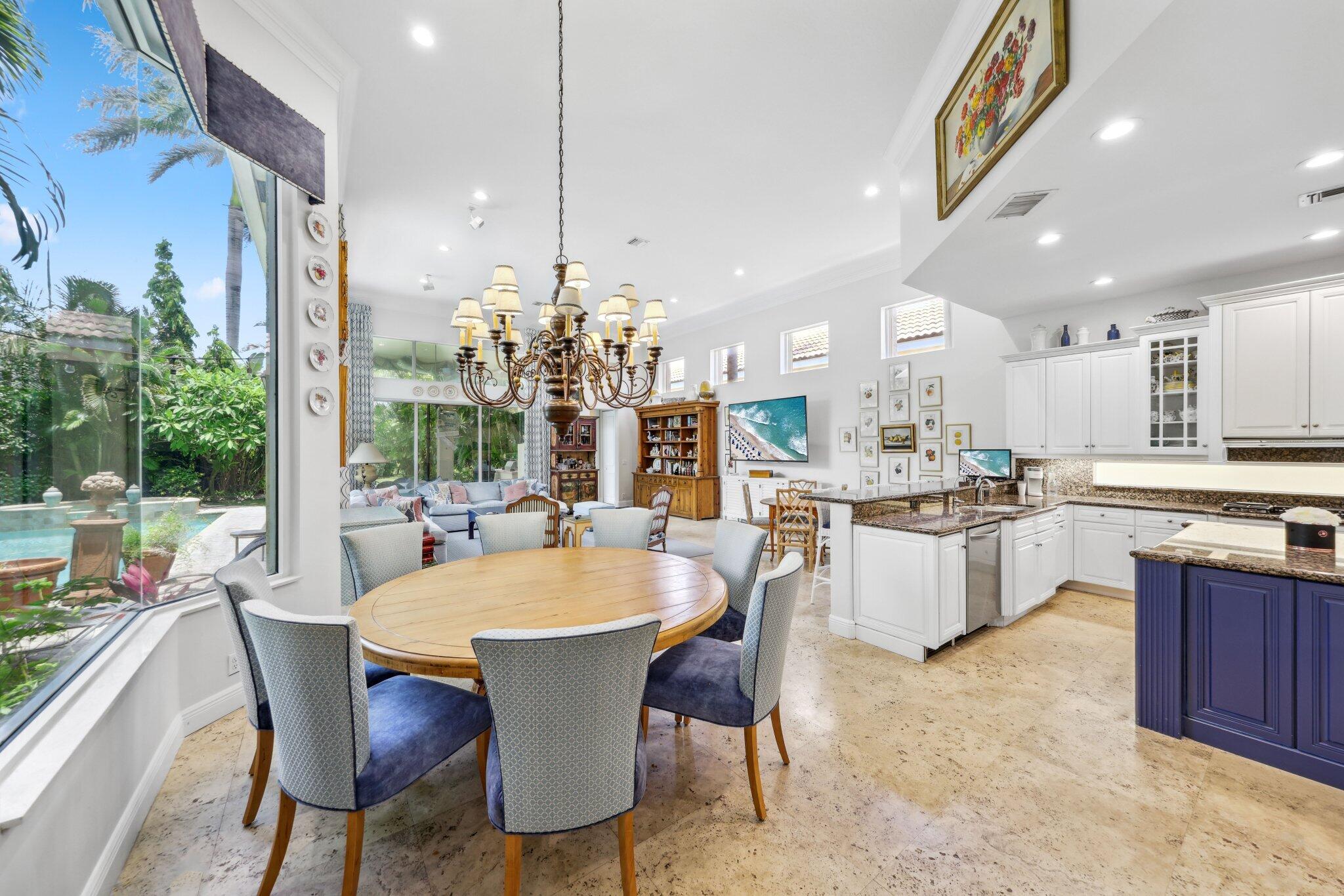 1018 Grand Court Highland Beach, FL 33487 - Photo 14 of 70 a large kitchen with a table and chairs