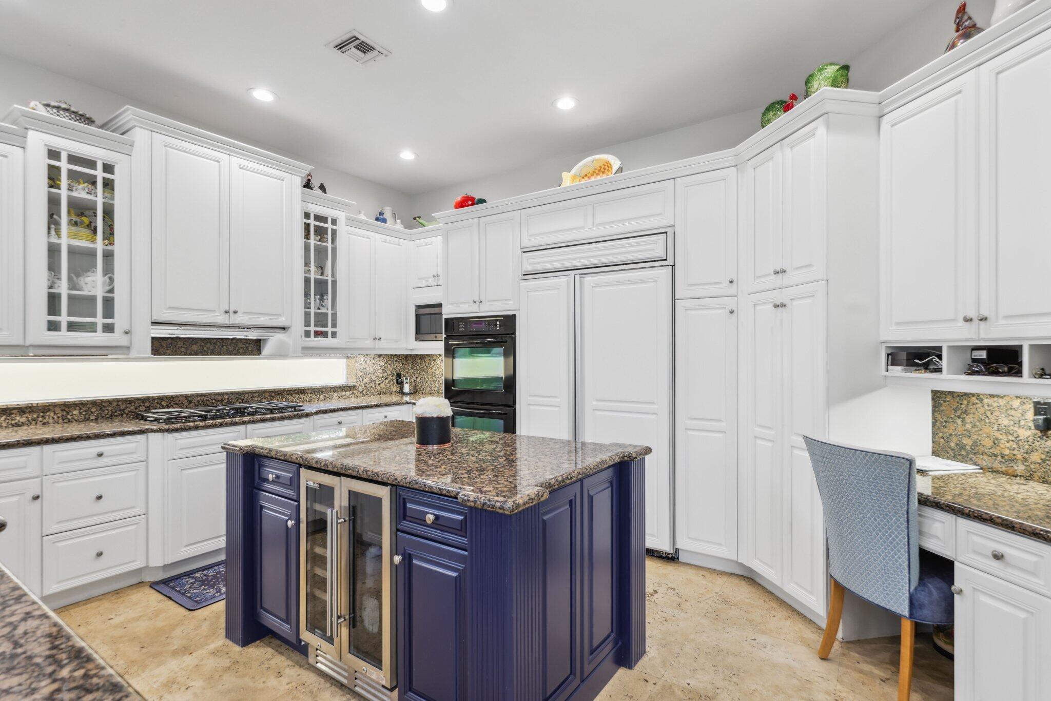 1018 Grand Court Highland Beach, FL 33487 - Photo 17 of 70 a kitchen with granite countertop a sink stove and cabinets