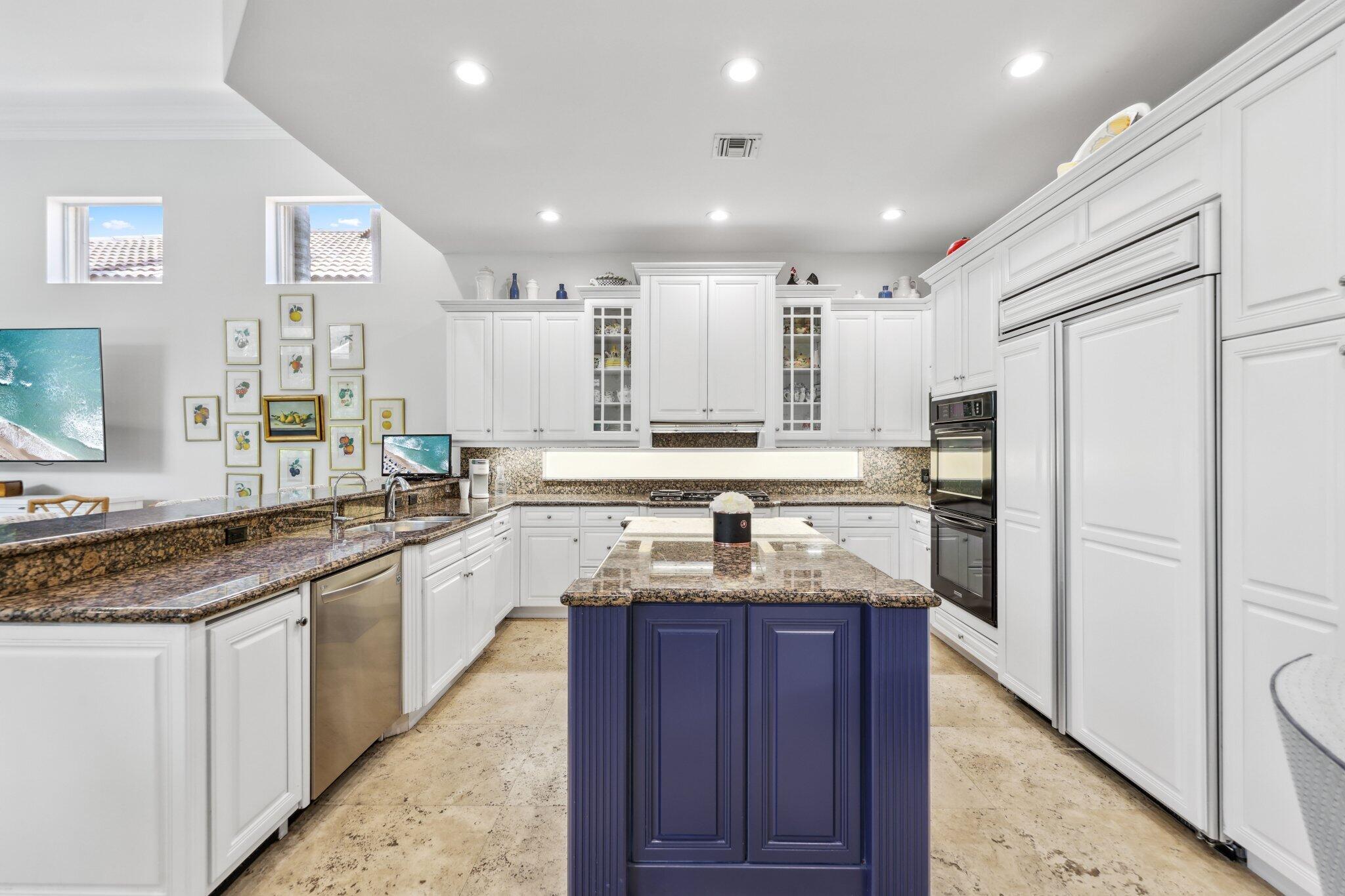 1018 Grand Court Highland Beach, FL 33487 - Photo 18 of 70 a kitchen with stainless steel appliances granite countertop a sink stove and refrigerator