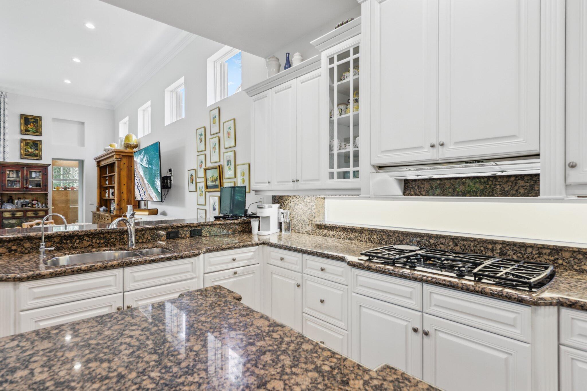 1018 Grand Court Highland Beach, FL 33487 - Photo 20 of 70 a kitchen with stainless steel appliances granite countertop a sink stove and cabinets