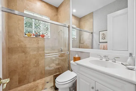 a spacious bathroom with a tub sink and mirror