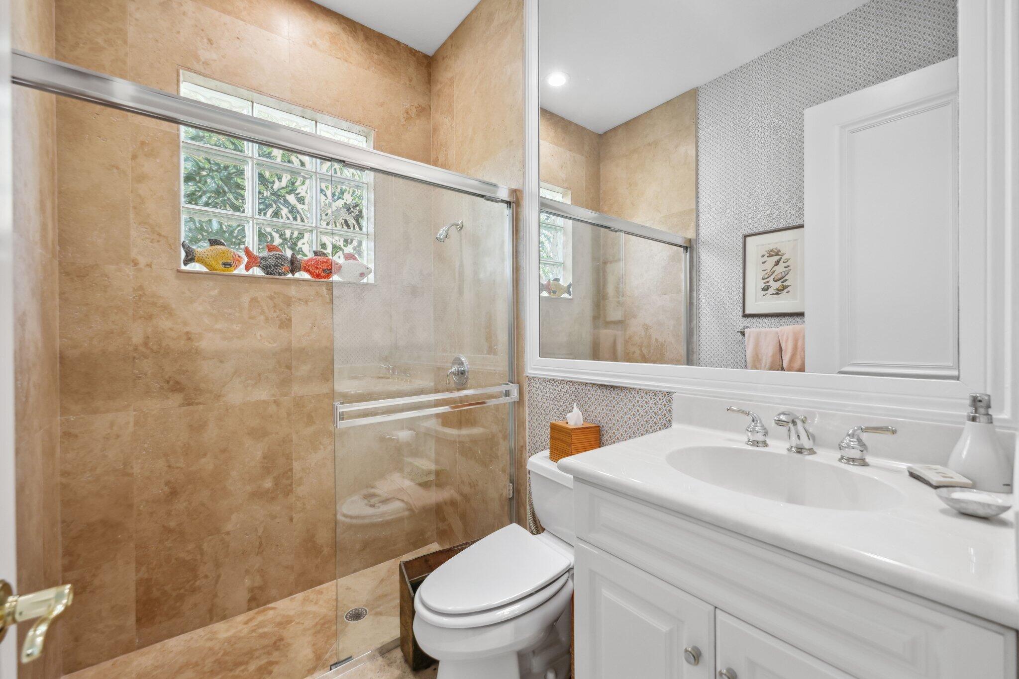 1018 Grand Court Highland Beach, FL 33487 - Photo 24 of 70 a bathroom with a sink toilet and shower