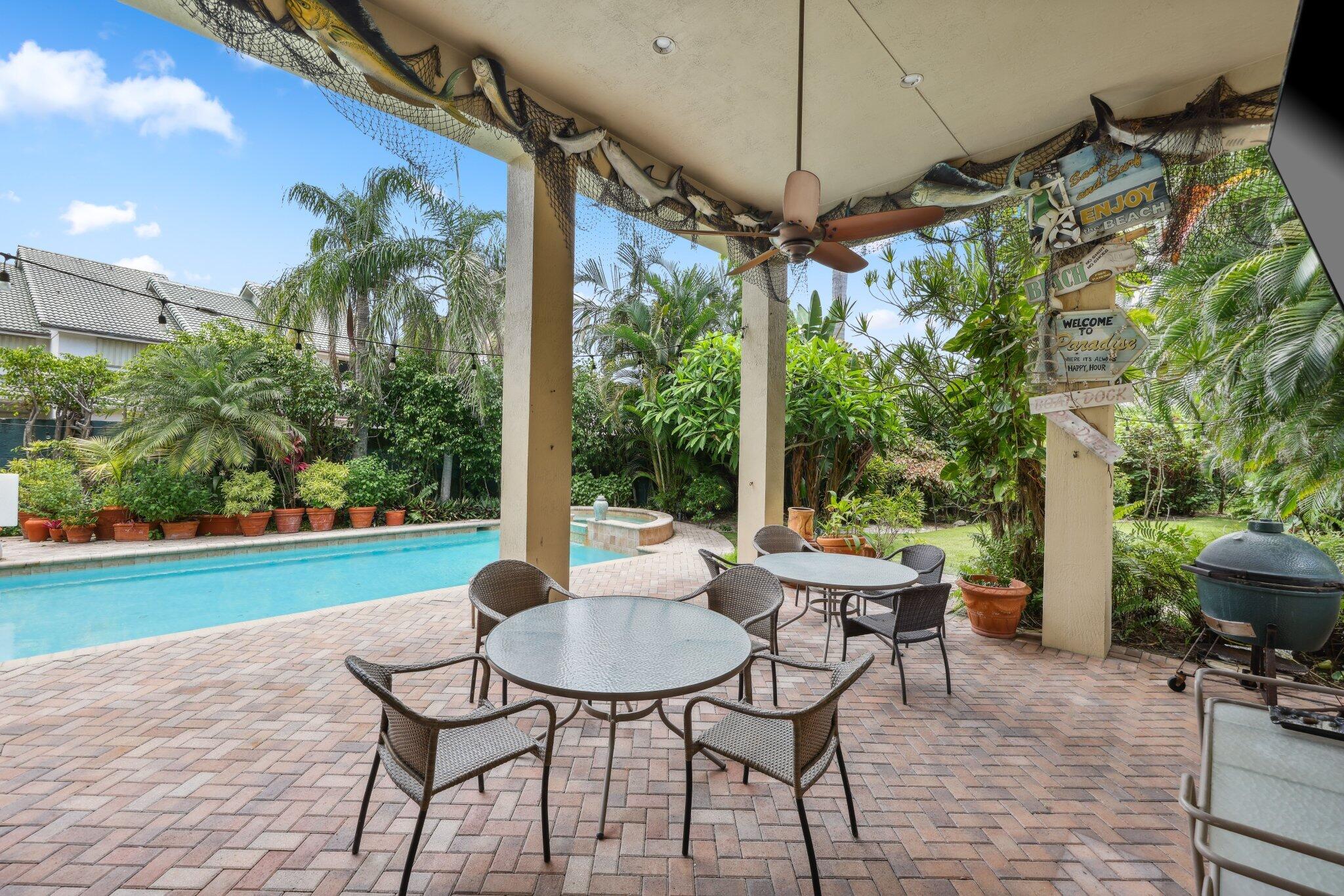 1018 Grand Court Highland Beach, FL 33487 - Photo 25 of 70 a patio with garden area and outdoor seating