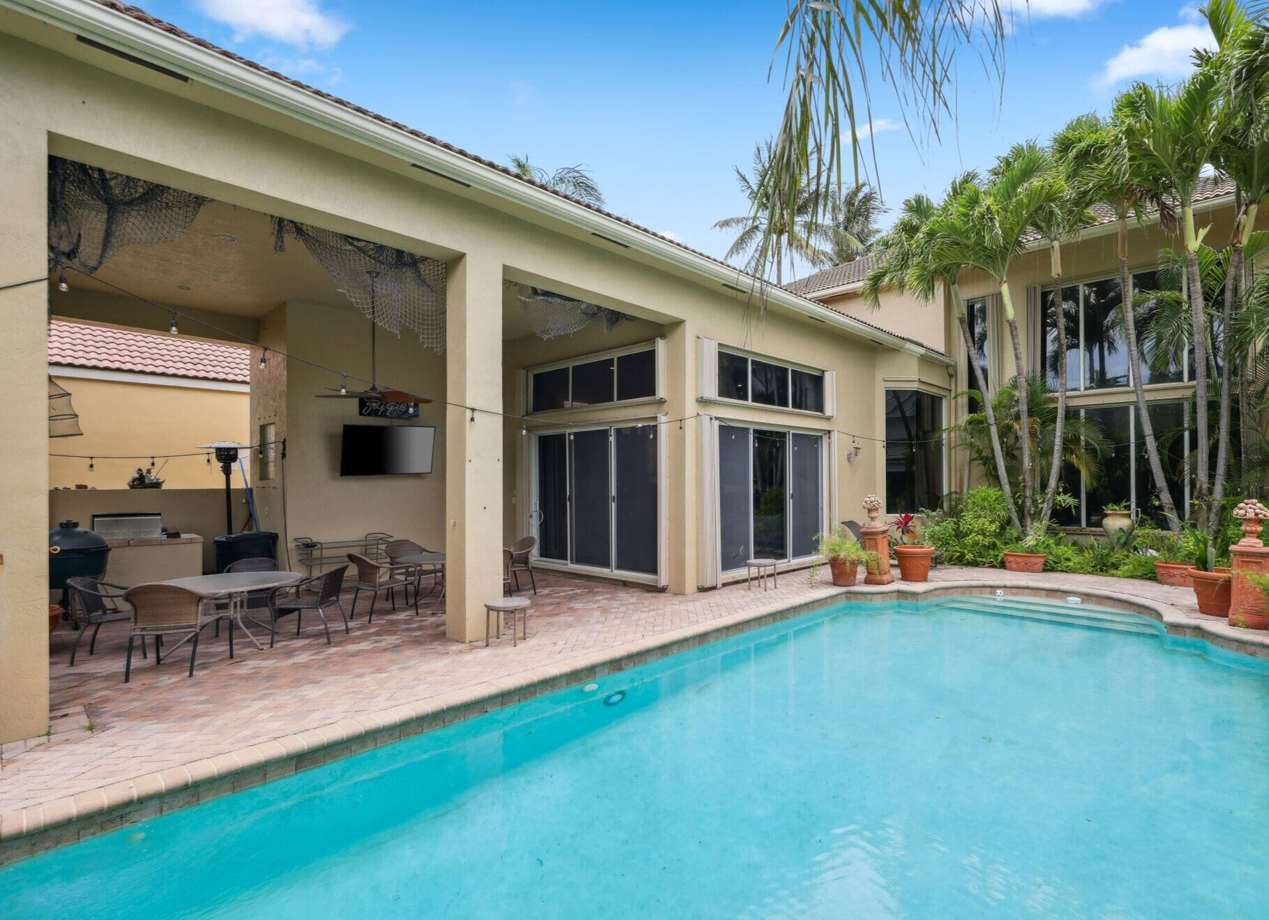 1018 Grand Court Highland Beach, FL 33487 - Photo 33 of 70 a view of a house with patio and a garden