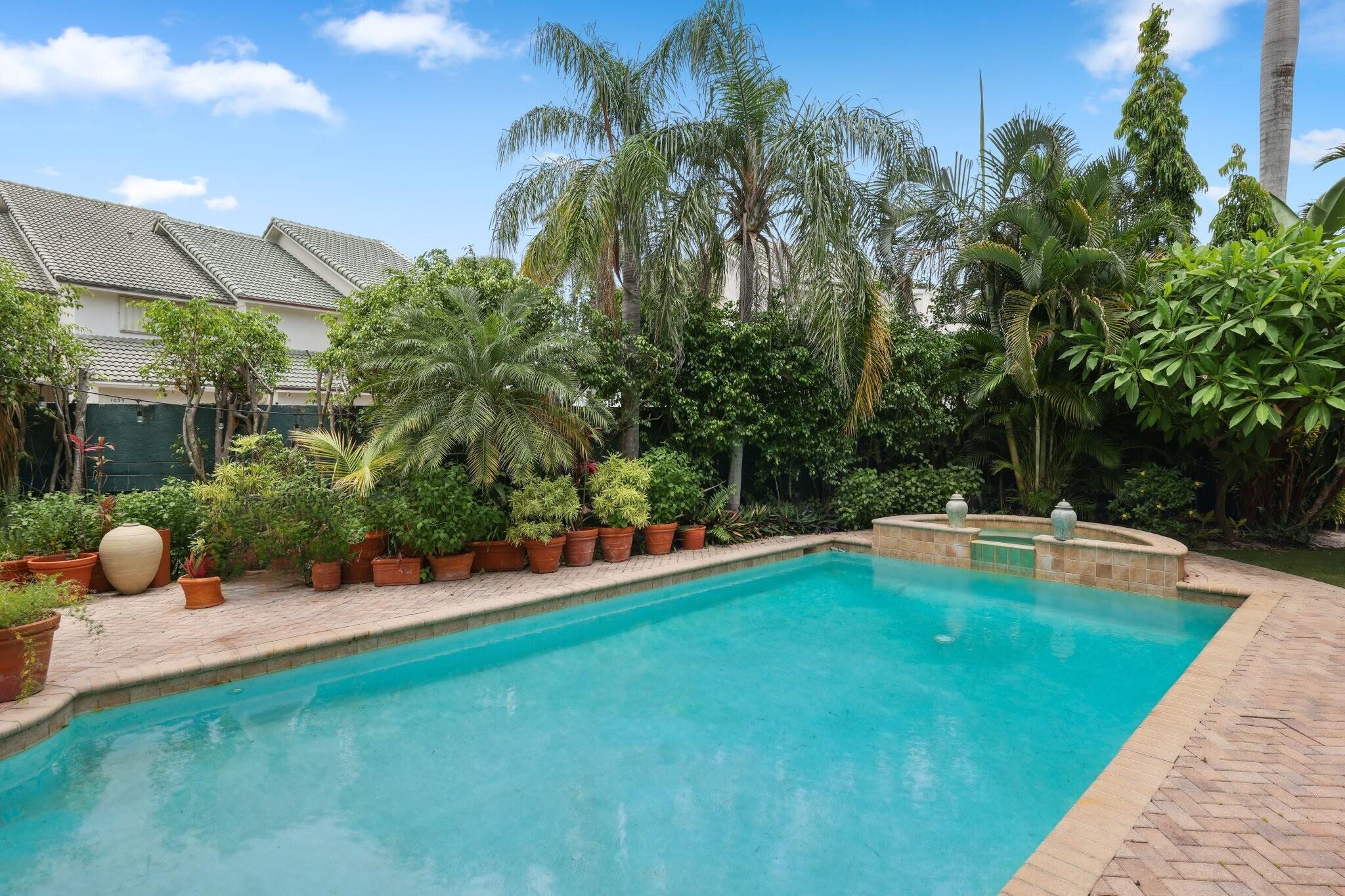 1018 Grand Court Highland Beach, FL 33487 - Photo 34 of 70 a view of a swimming pool with a patio and plants