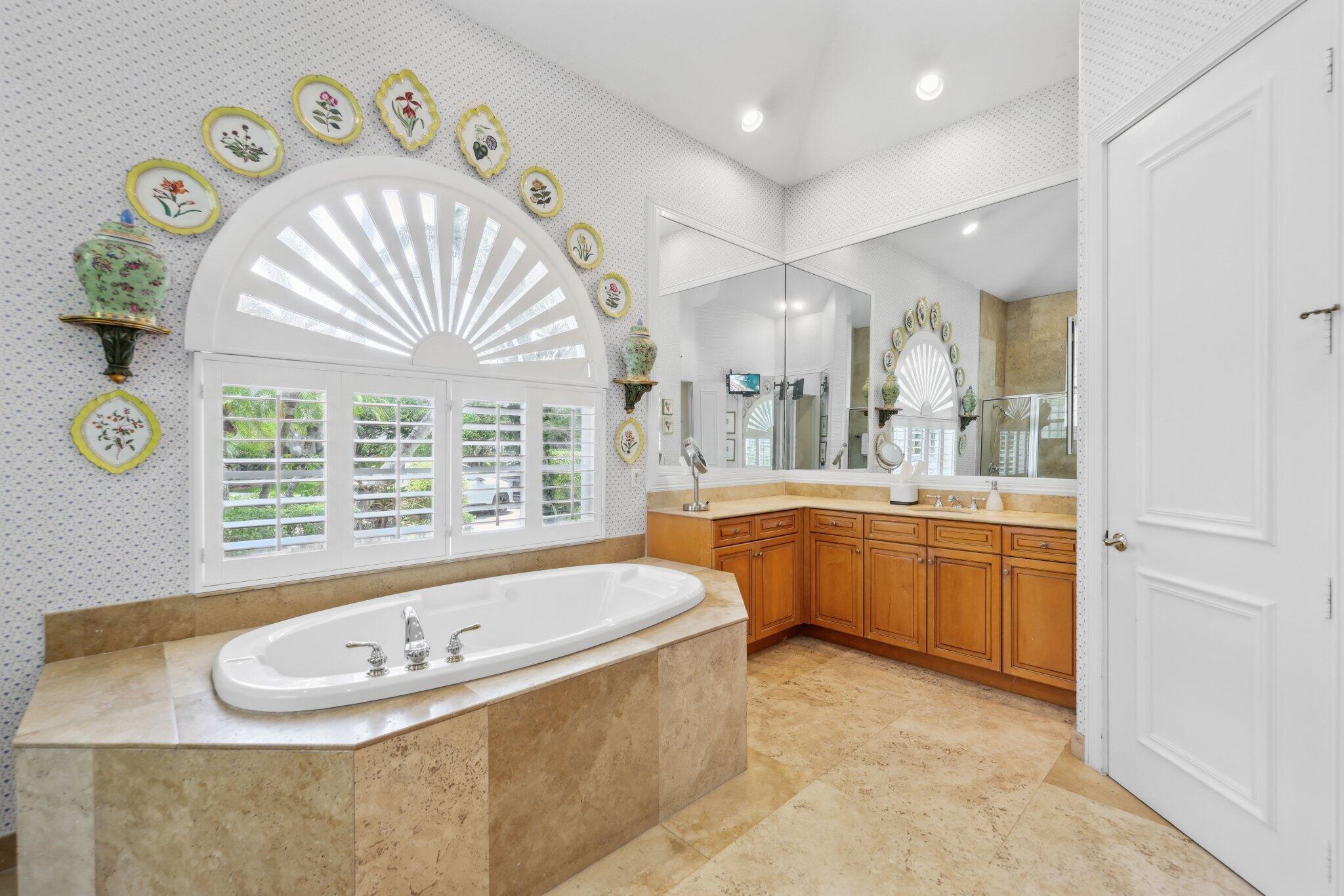 1018 Grand Court Highland Beach, FL 33487 - Photo 38 of 70 a spacious bathroom with a tub sink and mirror