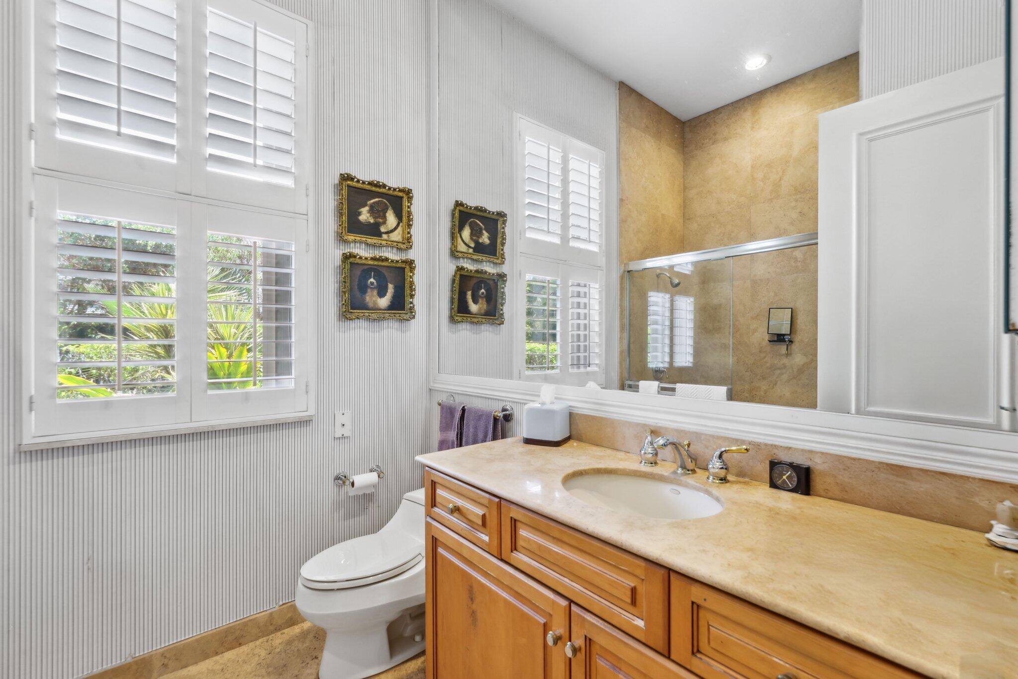 1018 Grand Court Highland Beach, FL 33487 - Photo 40 of 70 a bathroom with a granite countertop sink and a large mirror