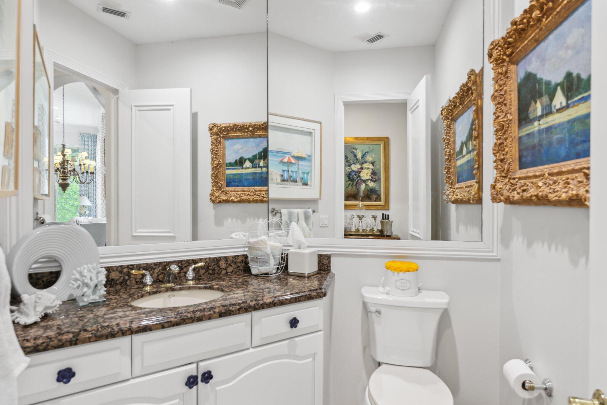 1018 Grand Court Highland Beach, FL 33487 - Photo 45 of 70 a bathroom with a granite countertop sink a mirror a bathtub and a shower