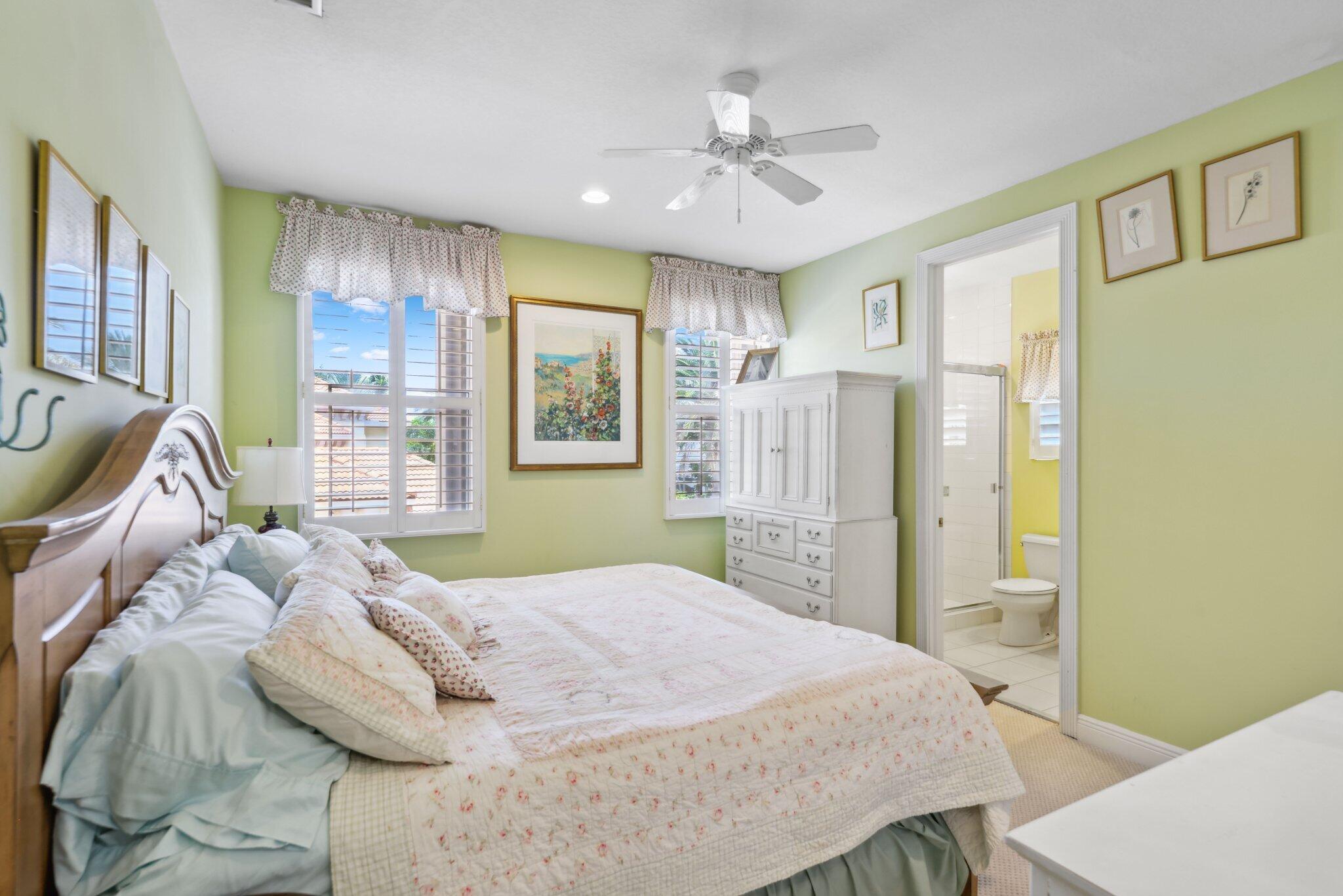 1018 Grand Court Highland Beach, FL 33487 - Photo 48 of 70 a bedroom with a bed and ceiling fan