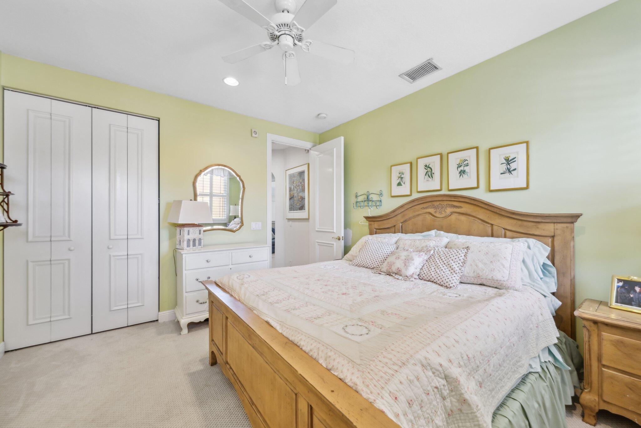 1018 Grand Court Highland Beach, FL 33487 - Photo 50 of 70 a bedroom with a large bed and a chandelier