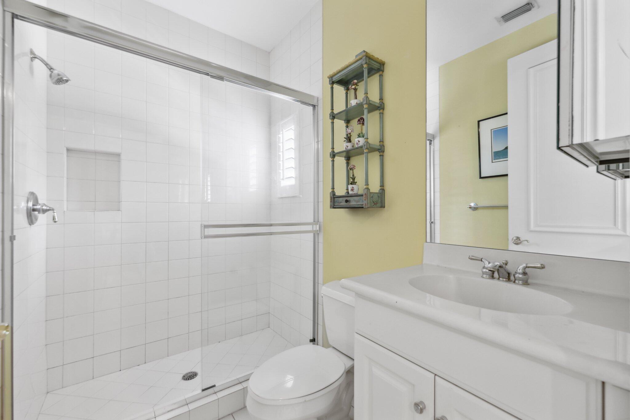 1018 Grand Court Highland Beach, FL 33487 - Photo 52 of 70 a bathroom with a sink a mirror and a shower