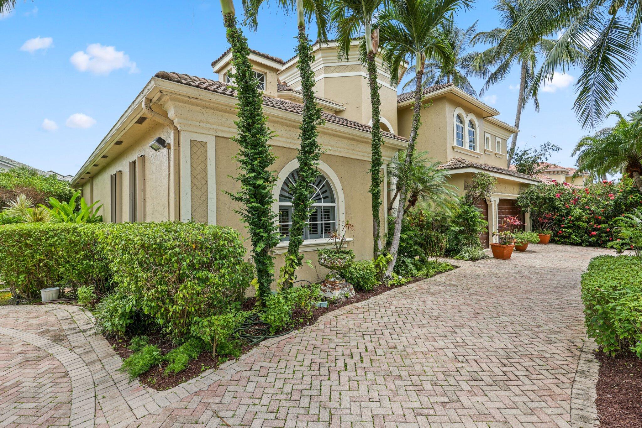 1018 Grand Court Highland Beach, FL 33487 - Photo 8 of 70 a front view of a multi story residential apartment building with yard and parking