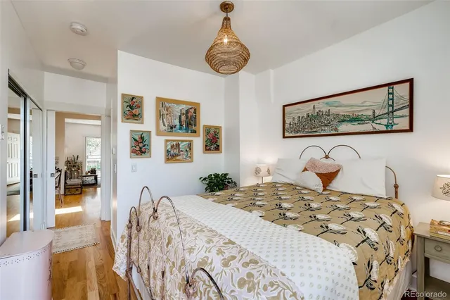 a bedroom with a large bed and a chandelier