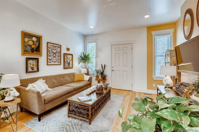 a living room with furniture a couch and a flat screen tv