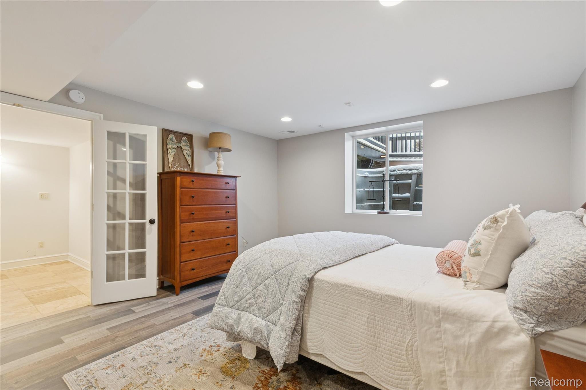 187 Darwin Road Pinckney, MI 48169 - Photo 42 of 71 Lower level Bedroom with french doors and egress window