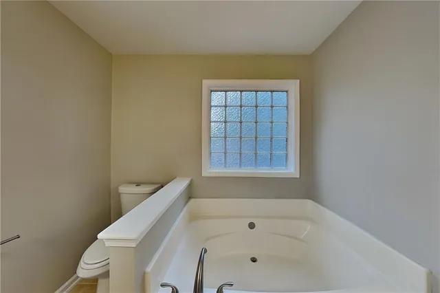 a bathroom with a bathtub and window