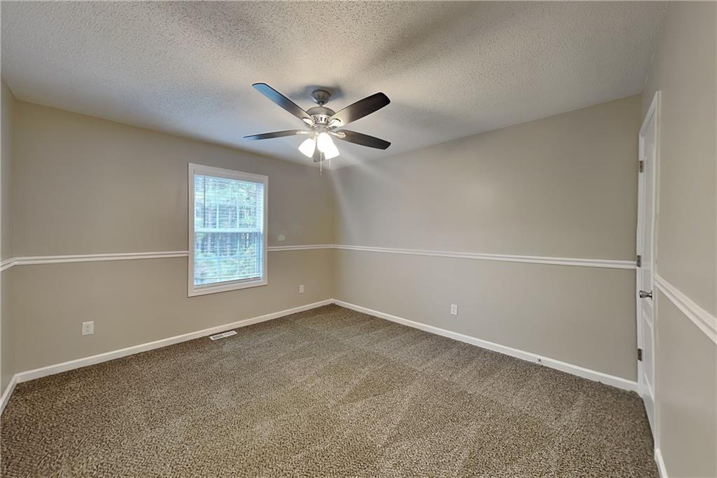 85 Ellen Glen Way Dallas, GA 30132 - Photo 13 of 21 an empty room with a window and a fan