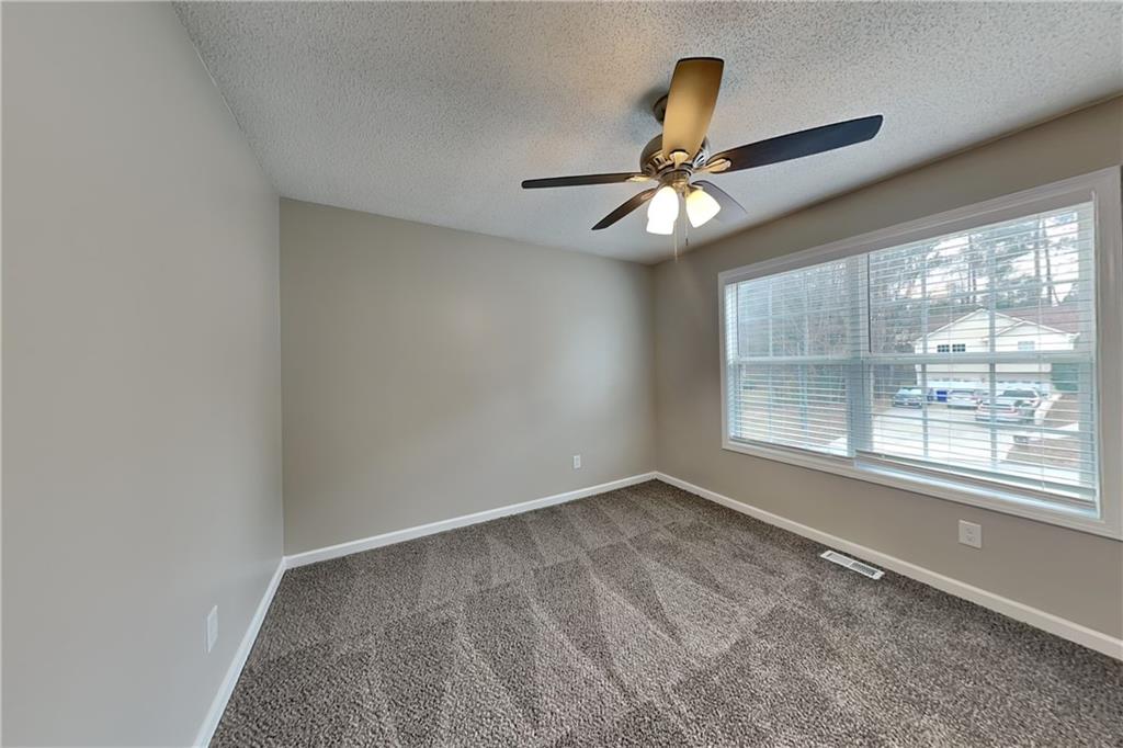85 Ellen Glen Way Dallas, GA 30132 - Photo 18 of 21 an empty room with windows and fan